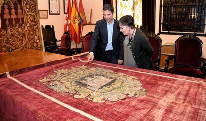 El alcalde de Alcalá, Javier Rodríguez Palacios, y la concejal de patrimonio histórico, Olga García, observando el tapiz del siglo XVII.