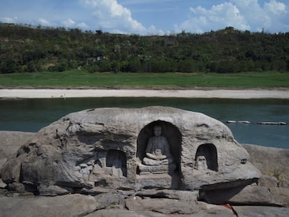 A once submerged Buddhist statue sits on top of Foyeliang island reef in the Yangtze river, which appeared after water levels fell due to a regional drought in Chongqing, China, August 20, 2022. REUTERS/Thomas Peter