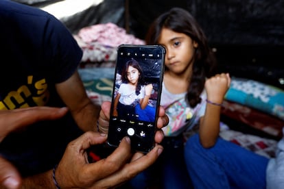 Una de las hijas del palestino Ali Daba -que decidió con su esposa separar a sus hijos e identificarlos con pulseras por si tenían que ser identificados tras ser alcanzados por los bombardeos- muestra su brazalete en un refugio de Jan Yunis, este miércoles, en el sur de la franja de Gaza.
