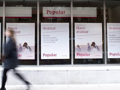 Una mujer pasa frente a una antigua sucursal de Banco Popular.