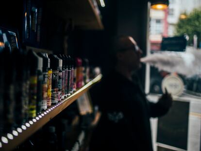 A consumer of electronic cigarettes vapes in an establishment dedicated to its sale in Santiago de Compostela, Spain.