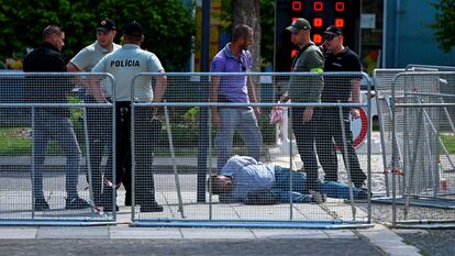 The alleged gunman, immobilized on the ground in Handlová on Wednesday.