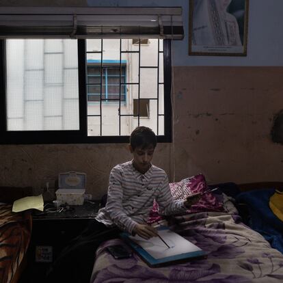 Rahif Almeari, a 13-year-old Palestinian artist, draws in his room. On the walls, the marks of bullet holes from the last outbreak of violence in Ein el-Hilweh, the largest Palestinian refugee camp in Lebanon.