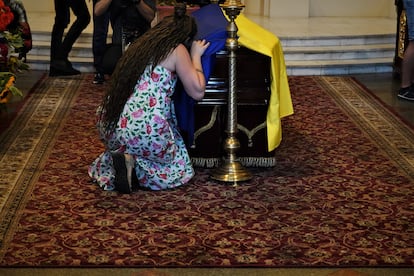 A woman hugs Ukrainian writer Victoria Amelina’s coffin at her funeral on Tuesday in Kyiv, Ukraine