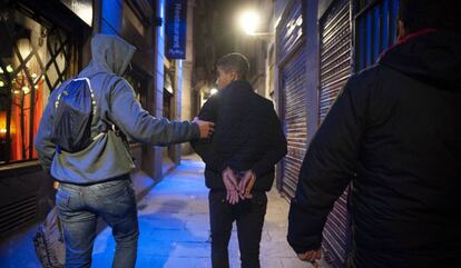 A youth being detained in Barcelona.