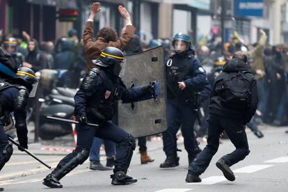 Polícia antidistúrbios avança contra ou grupo de manifestantes durante um protesto dos trabalhadores da SNCF, a empresa nacional de trens da França, e estudantes em Paris.