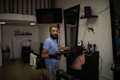 Wadia dries a client's hair at his salon in Rmeish.