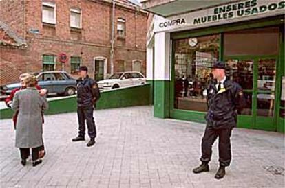 Dos policías custodiaban ayer la tienda de antigüedades Viana 35 tras ser retirado el cadáver de su dueño.