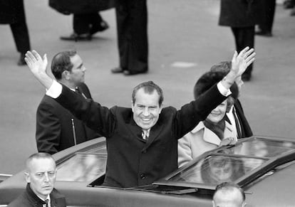 El presidente Richard M. Nixon, acompañado de su esposa Pat, saluda durante su traslado desde el Capitolio hasta la Casa Blanca tras jurar el cargo el 20 de enero de 1969. 