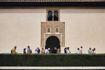 Gardeners work under the gaze of the 8,000 tourists who visit every day.