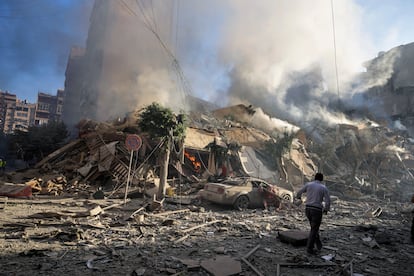 Un hombre observa los restos humeantes de un edificio del barrio de Dahiye de Beirut destruido por un ataque israelí en la madrugada de este jueves.