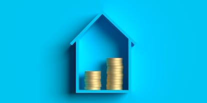 Blue house model and gold coin stack for Mortgage Investment