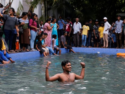 A man stands in the swimming pool as people visit the President's house on the day after demonstrators entered the building, after President Gotabaya Rajapaksa fled, amid the country's economic crisis, in Colombo, Sri Lanka July 10, 2022. REUTERS/Dinuka Liyanawatte