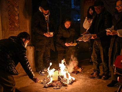 Wuhan residents burn offerings to pay tribute to relatives who passed away last year on Lunar New Year's Eve, January 21.