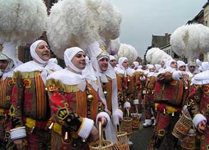 Martes de carnaval en Binche, Bélgica. Los Gilles, con sus penachos  de plumas de avestruz, ofrecen a la gente naranjas que acarrean en  cestas de mimbre.