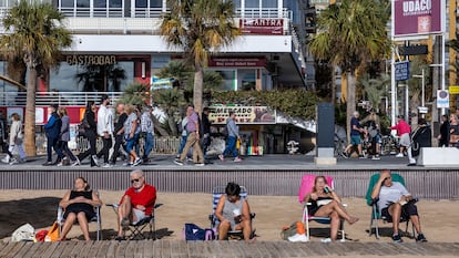 Varios turistas en la playa y en el paseo de la playa del Levante de Benidorm, este diciembre.