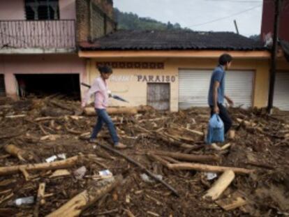 Vecinos de El Para&iacute;so, Guerrero, caminan sobre los escombros que dej&oacute; un temporal