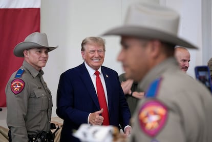 Donald Trump helps serve food to Texas National Guard soldiers, troopers and others, on Nov. 19, 2023, in Edinburg, Texas.