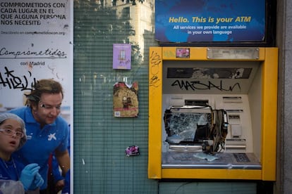 A vandalized ATM in Lavapiés.