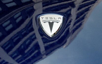 A logo of Tesla Motors on an electric car model is seen outside a showroom in New York