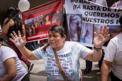 Relatives pray in front of the North Judicial Complex during a protest.