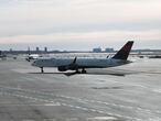 NEW YORK, NEW YORK - JANUARY 25: A plane sits on a tarmac at an international terminal at John F. Kennedy Airport (JFK) on January 25, 2021 in New York City. In an effort to further control Covid-19 transmission, President Joe Biden plans to sign restrictions on travel to the United States. The ban will prohibit travelers from the United Kingdom, Ireland and 26 countries in Europe that allow travel across open borders, called the Schengen Area. The new measures will also block entry to travelers from Brazil and South Africa.   Spencer Platt/Getty Images/AFP
== FOR NEWSPAPERS, INTERNET, TELCOS & TELEVISION USE ONLY ==