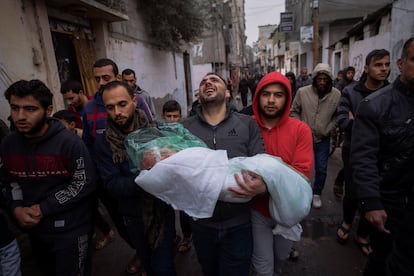 A man carries the body of his daughter, Masa, at her funeral in Rafah on January 17.