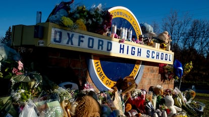 Family, friends, students, and relatives of victims put up bouquets of flowers, candles and personalized messages at a memorial near an entrance to the Oxford High School in 2021 in Oxford, Michigan.