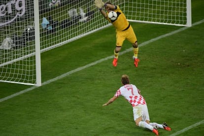 Spanish goalkeeper Iker Casillas saves a header by Croatian midfielder Ivan Rakitic in the Gdansk Arena.