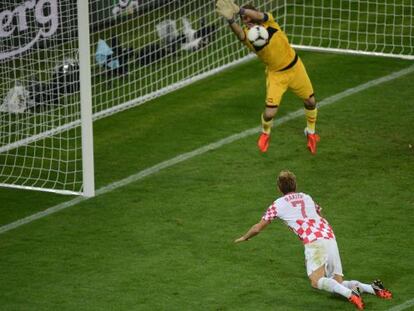 Spanish goalkeeper Iker Casillas saves a header by Croatian midfielder Ivan Rakitic in the Gdansk Arena.    