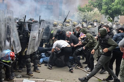 NATO Kosovo Force soldiers clash with local Kosovo Serb protesters at the entrance of the municipality office in Kosovo