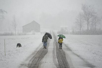 Una pareja camina sobre un paisaje cubierto de nieve en Sargans (Suiza).