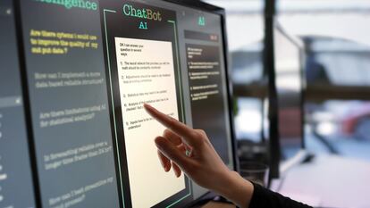 Una mujer toca una pantalla con una aplicación que utiliza inteligencia artificial.