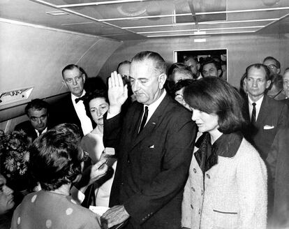 Lyndon B. Johnson juró su cargo horas después de que hubieran asesinado a Kennedy, junto a la viuda del presidente.
