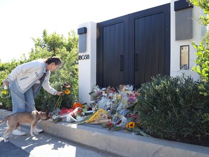 A person leaves flowers outside the home of late actor Matthew Perry in Pacific Palisades, California, U.S., October 31, 2023.