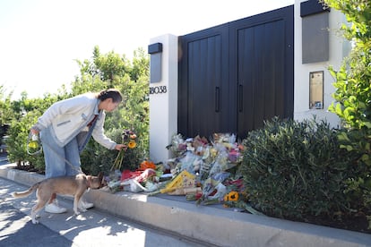 A person leaves flowers outside the home of late actor Matthew Perry in Pacific Palisades, California, U.S., October 31, 2023