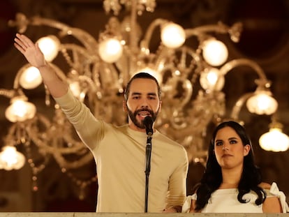 Salvadoran President Nayib Bukele and his wife, Gabriela Rodríguez, address a crowd of supporters from the presidential balcony on Sunday night.
