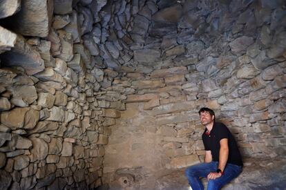 Miquel Palau inside one of the restored dry stone 'tinas' in the Bages region, in central Catalonia. Winegrowers used to spend long hours in these 18th and 19th-century structures, sometimes even sleeping there to guard the wine. 