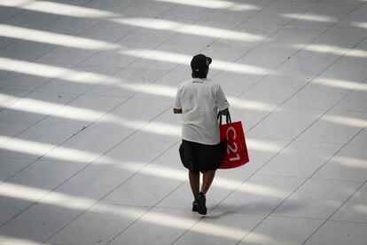 A woman carries a Century21 shopping bag while walking through a mall on Tuesday June 6, 2023, in New York.