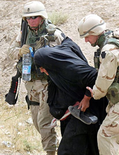 Dos policías militares de EE UU atienden a una mujer enferma en Faluya.