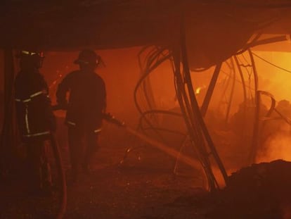 Dos bomberos en el interior del edificio.