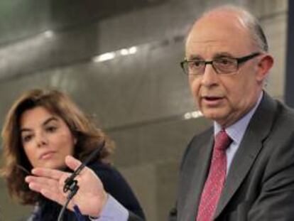 El ministro de Hacienda y Administraciones Públicas, Cristóbal Montoro, durante la rueda de que prensa que ofreció junto al titular de Economía, Luis de Guindos, y la vicepresidenta del Gobierno, Soraya Sáenz de Santamaría, al término de la reunión del Consejo de Ministros en la que se aprobó el proyecto de Presupuestos Generales del Estado para 2013.