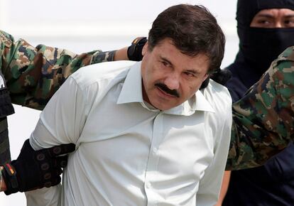 In this Feb. 22, 2014 file photo, Joaquin "El Chapo" Guzman, the head of Mexico's Sinaloa Cartel, is escorted to a helicopter in Mexico City following his capture in the beach resort town of Mazatlan, Mexico.