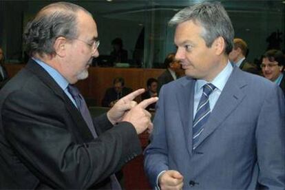 Pedro Solbes (a la izquierda) conversa con su homólogo belga, Didier Reynders, al inicio de la reunión en Bruselas.