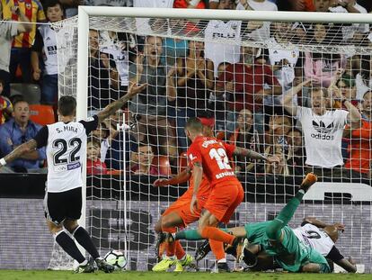 Santi Mina remata a porter&iacute;a durante el partido contra el M&aacute;laga en Mestalla.