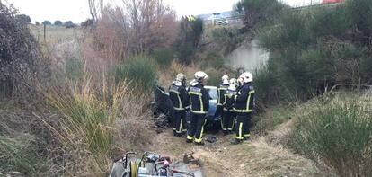 Bomberos en lugar del accidente donde murieron los dos ocupantes.