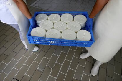 At the foot of an impressive rocky outcrop is Villaluenga del Rosario, the highest village in Cádiz province. In this image, cheese makers from the firm Payoya hold up a tray of goats cheese.