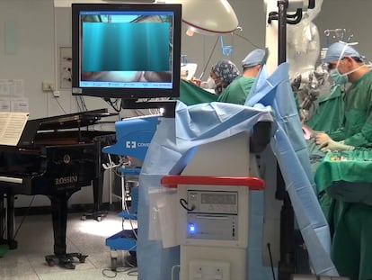 A still image taken from a video shows medical staff led by Dr. Roberto Trignani performing surgery to remove a double tumour in the spinal cord of a 10-year-old child as molecular biologist Emiliano Toso plays music on the piano with a frequency believed to have a therapeutic affect on the patient at the Salesi Pediatric Hospital in Ancona, Italy, November 16, 2020. Picture taken November 16, 2020. Fondazione Salesi/Handout via REUTERS ATTENTION EDITORS THIS IMAGE HAS BEEN SUPPLIED BY A THIRD PARTY. NO ARCHIVE. NO RESALE.