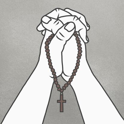 Cropped image of clasped hands holding rosary beads against gray background