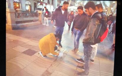 Un grupo de jóvenes tapa el monumento a las víctimas del atentado de La Rambla de Barcelona.